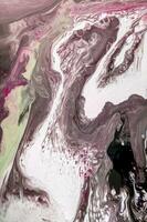 Abstract created using the technique of liquid acrylic. Macro photography of the smallest details of a picture. The picture shows how overflows of shades and colors of paint resemble space motifs. photo