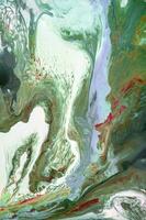 Abstract created using the technique of liquid acrylic. Macro photography of the smallest details of a picture. The picture shows how overflows of shades and colors of paint resemble space motifs. photo