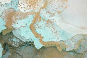 The picture is painted in alcohol ink. Creative abstract artwork made with translucent ink colors. Trendy wallpaper. Abstract painting, can be used as a background for wallpapers, posters, websites. photo