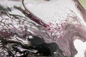 Abstract created using the technique of liquid acrylic. Macro photography of the smallest details of a picture. The picture shows how overflows of shades and colors of paint resemble space motifs. photo