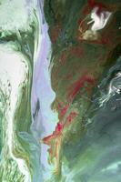 Abstract created using the technique of liquid acrylic. Macro photography of the smallest details of a picture. The picture shows how overflows of shades and colors of paint resemble space motifs. photo
