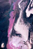 Abstract created using the technique of liquid acrylic. Macro photography of the smallest details of a picture. The picture shows how overflows of shades and colors of paint resemble space motifs. photo