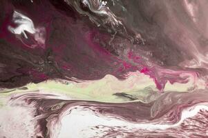 Abstract created using the technique of liquid acrylic. Macro photography of the smallest details of a picture. The picture shows how overflows of shades and colors of paint resemble space motifs. photo