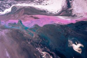 Abstract created using the technique of liquid acrylic. Macro photography of the smallest details of a picture. The picture shows how overflows of shades and colors of paint resemble space motifs. photo