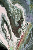 Abstract created using the technique of liquid acrylic. Macro photography of the smallest details of a picture. The picture shows how overflows of shades and colors of paint resemble space motifs. photo