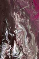 Abstract created using the technique of liquid acrylic. Macro photography of the smallest details of a picture. The picture shows how overflows of shades and colors of paint resemble space motifs. photo