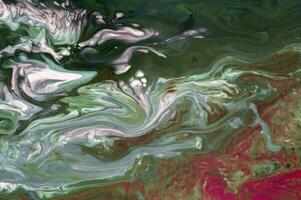 Abstract created using the technique of liquid acrylic. Macro photography of the smallest details of a picture. The picture shows how overflows of shades and colors of paint resemble space motifs. photo