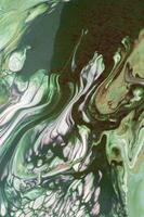 Abstract created using the technique of liquid acrylic. Macro photography of the smallest details of a picture. The picture shows how overflows of shades and colors of paint resemble space motifs. photo