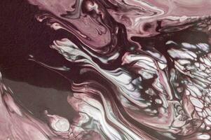 Abstract created using the technique of liquid acrylic. Macro photography of the smallest details of a picture. The picture shows how overflows of shades and colors of paint resemble space motifs. photo