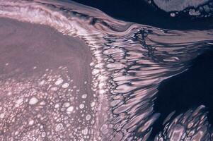 Abstract created using the technique of liquid acrylic. Macro photography of the smallest details of a picture. The picture shows how overflows of shades and colors of paint resemble space motifs. photo