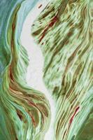 Abstract created using the technique of liquid acrylic. Macro photography of the smallest details of a picture. The picture shows how overflows of shades and colors of paint resemble space motifs. photo