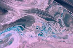 Abstract created using the technique of liquid acrylic. Macro photography of the smallest details of a picture. The picture shows how overflows of shades and colors of paint resemble space motifs. photo