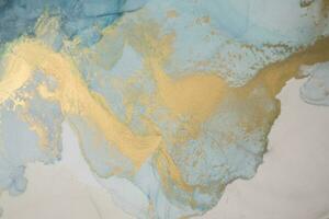 Alcohol ink sea texture. Artistic bright splash. Liquid artwork. Abstract ethereal swirl. Fragment of artwork. Trendy modern art. Inspired by the sky, as well as steam and smoke. photo