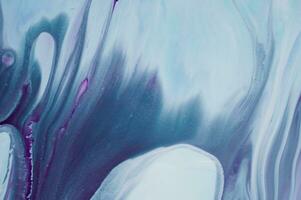 Abstract created using the technique of liquid acrylic. Macro photography of the smallest details of a panting. The panting shows how overflows of shades and colors of paint resemble space motifs. photo