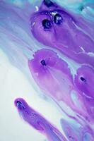 Abstract created using the technique of liquid acrylic. Macro photography of the smallest details of a panting. The panting shows how overflows of shades and colors of paint resemble space motifs. photo