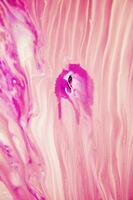 Abstract created using the technique of liquid acrylic. Macro photography of the smallest details of a panting. The panting shows how overflows of shades and colors of paint resemble space motifs. photo