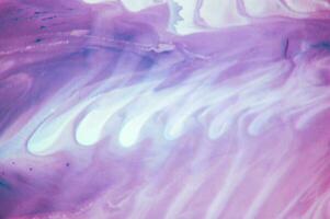 Abstract created using the technique of liquid acrylic. Macro photography of the smallest details of a panting. The panting shows how overflows of shades and colors of paint resemble space motifs. photo