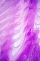 Abstract created using the technique of liquid acrylic. Macro photography of the smallest details of a panting. The panting shows how overflows of shades and colors of paint resemble space motifs. photo