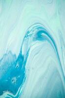 Abstract created using the technique of liquid acrylic. Macro photography of the smallest details of a panting. The panting shows how overflows of shades and colors of paint resemble space motifs. photo