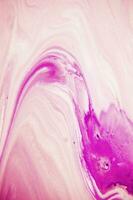 Abstract created using the technique of liquid acrylic. Macro photography of the smallest details of a panting. The panting shows how overflows of shades and colors of paint resemble space motifs. photo