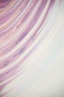 Abstract created using the technique of liquid acrylic. Macro photography of the smallest details of a panting. The panting shows how overflows of shades and colors of paint resemble space motifs. photo