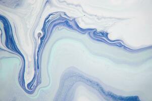 Abstract created using the technique of liquid acrylic. Macro photography of the smallest details of a panting. The panting shows how overflows of shades and colors of paint resemble space motifs. photo