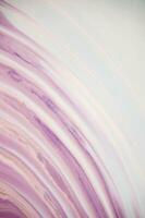 Abstract created using the technique of liquid acrylic. Macro photography of the smallest details of a panting. The panting shows how overflows of shades and colors of paint resemble space motifs. photo