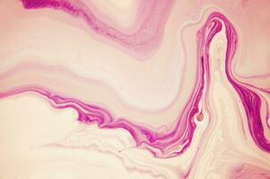Abstract created using the technique of liquid acrylic. Macro photography of the smallest details of a panting. The panting shows how overflows of shades and colors of paint resemble space motifs. photo