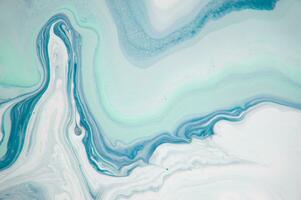 Abstract created using the technique of liquid acrylic. Macro photography of the smallest details of a panting. The panting shows how overflows of shades and colors of paint resemble space motifs. photo