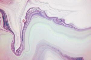 Abstract created using the technique of liquid acrylic. Macro photography of the smallest details of a panting. The panting shows how overflows of shades and colors of paint resemble space motifs. photo