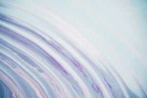 Abstract created using the technique of liquid acrylic. Macro photography of the smallest details of a panting. The panting shows how overflows of shades and colors of paint resemble space motifs. photo