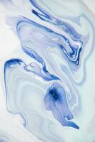 Abstract created using the technique of liquid acrylic. Macro photography of the smallest details of a panting. The panting shows how overflows of shades and colors of paint resemble space motifs. photo