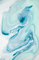 Abstract created using the technique of liquid acrylic. Macro photography of the smallest details of a panting. The panting shows how overflows of shades and colors of paint resemble space motifs. photo