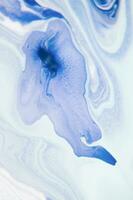 Abstract created using the technique of liquid acrylic. Macro photography of the smallest details of a panting. The panting shows how overflows of shades and colors of paint resemble space motifs. photo