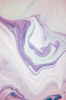 Abstract created using the technique of liquid acrylic. Macro photography of the smallest details of a panting. The panting shows how overflows of shades and colors of paint resemble space motifs. photo