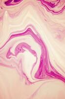 Abstract created using the technique of liquid acrylic. Macro photography of the smallest details of a panting. The panting shows how overflows of shades and colors of paint resemble space motifs. photo