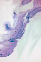 Abstract created using the technique of liquid acrylic. Macro photography of the smallest details of a panting. The panting shows how overflows of shades and colors of paint resemble space motifs. photo