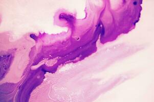 Abstract created using the technique of liquid acrylic. Macro photography of the smallest details of a panting. The panting shows how overflows of shades and colors of paint resemble space motifs. photo