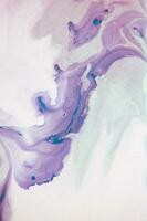 Abstract created using the technique of liquid acrylic. Macro photography of the smallest details of a panting. The panting shows how overflows of shades and colors of paint resemble space motifs. photo