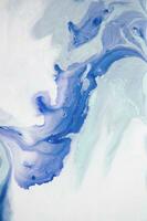 Abstract created using the technique of liquid acrylic. Macro photography of the smallest details of a panting. The panting shows how overflows of shades and colors of paint resemble space motifs. photo