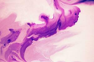 Abstract created using the technique of liquid acrylic. Macro photography of the smallest details of a panting. The panting shows how overflows of shades and colors of paint resemble space motifs. photo