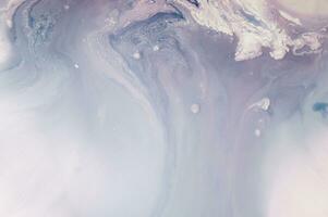Abstract created using the technique of liquid acrylic. Macro photography of the smallest details of a panting. The panting shows how overflows of shades and colors of paint resemble space motifs. photo