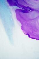 Abstract created using the technique of liquid acrylic. Macro photography of the smallest details of a panting. The panting shows how overflows of shades and colors of paint resemble space motifs. photo