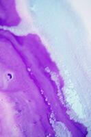 Abstract created using the technique of liquid acrylic. Macro photography of the smallest details of a panting. The panting shows how overflows of shades and colors of paint resemble space motifs. photo