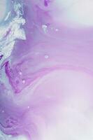 Abstract created using the technique of liquid acrylic. Macro photography of the smallest details of a panting. The panting shows how overflows of shades and colors of paint resemble space motifs. photo