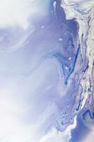Abstract created using the technique of liquid acrylic. Macro photography of the smallest details of a panting. The panting shows how overflows of shades and colors of paint resemble space motifs. photo