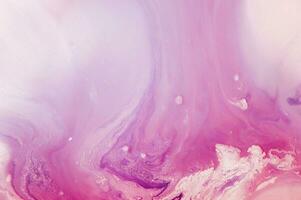 Abstract created using the technique of liquid acrylic. Macro photography of the smallest details of a panting. The panting shows how overflows of shades and colors of paint resemble space motifs. photo