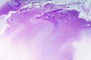 Abstract created using the technique of liquid acrylic. Macro photography of the smallest details of a panting. The panting shows how overflows of shades and colors of paint resemble space motifs. photo