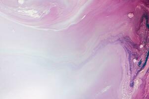 Abstract created using the technique of liquid acrylic. Macro photography of the smallest details of a panting. The panting shows how overflows of shades and colors of paint resemble space motifs. photo