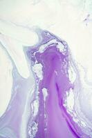 Abstract created using the technique of liquid acrylic. Macro photography of the smallest details of a panting. The panting shows how overflows of shades and colors of paint resemble space motifs. photo